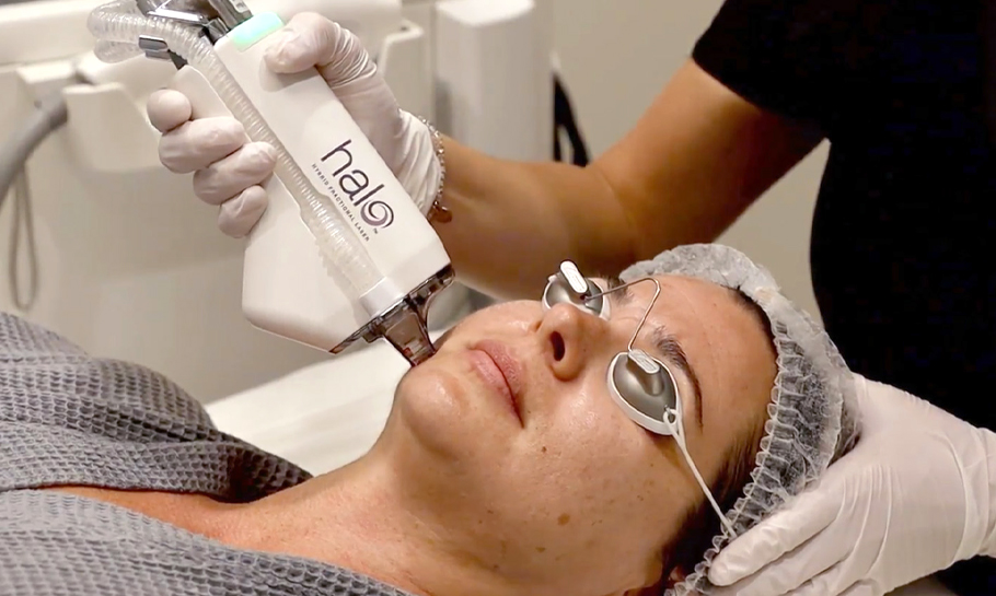 Medical provider administering Halo laser treatment to patient.